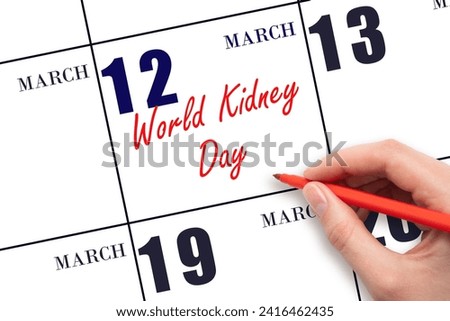 March 12. Hand writing text World Kidney Day on calendar date. Save the date. Holiday.  Day of the year concept.