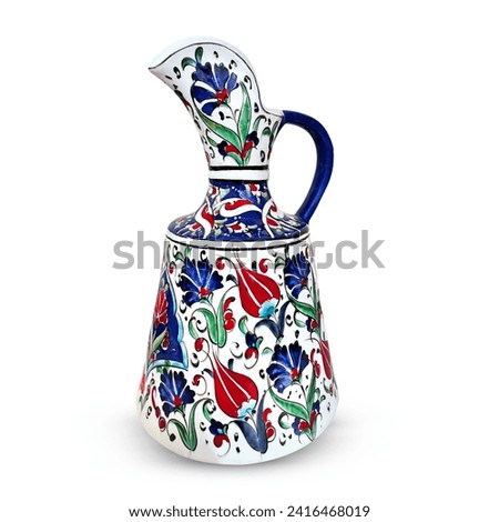 Bursa, iznik pottery. Image of a jug made from pottery, with red, blue and green floral designs, in front of a solid background. Porcelain vases with painting. Royalty-Free Stock Photo #2416468019
