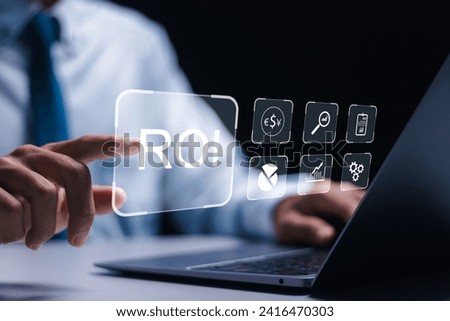 ROI Return on investment financial growth concept. businessman use laptop with virtual ROI icons. Royalty-Free Stock Photo #2416470303