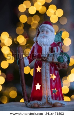 Santa Claus in front of the tree that makes bokeh light
