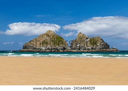 Gull rocks, also known as Carter's islands, are located 500 metres off Holywell Bay beach near Newquay, Cornwall. Royalty-Free Stock Photo #2416484029