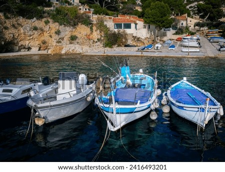 Wooden fishing boats and modern motor boats are moored on the Côte d'Azur on the Calanque coast.  Beautiful bright picture of nature.  A heavenly place to relax. Rural area with a sharp downward slope
