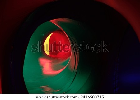Abstract image featuring vibrant illuminate red, blue, pink, and green lights, creating a colorful and dynamic abstract display. Perfect for a modern and electric-themed background in nightlife  Royalty-Free Stock Photo #2416503715