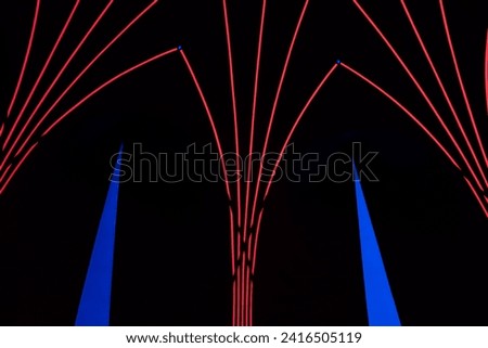 vibrant illuminate red, blue, and neon lights in geometric triangle shapes, creating a colorful and dynamic abstract display. A modern and electric-themed symmetry background