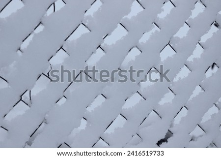 Background from snow fence. Winter garden.