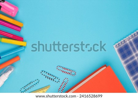 Back to school. Stationery on a blue table. Office desk with copy space. Flat lay