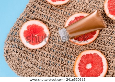 Self-tanning cream or lotion for face or body with vitamin C. Self-tanning product. Moisturising body care. Summer mood. top view. High quality photo Royalty-Free Stock Photo #2416530365