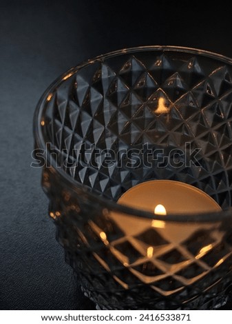 This picture taken by me without using any third party or AI The fire candle glass exudes warmth and charm. With a flickering flame encased in transparent elegance, it adds sophistication to any space
