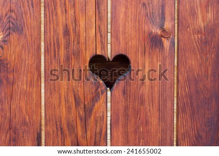 Old brown wood texture with heart shaped whole