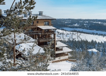 winter landscape with coniferous trees in a ski resort with ski slopes