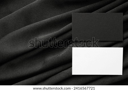 Blank business cards on black fabric, top view. Mockup for design