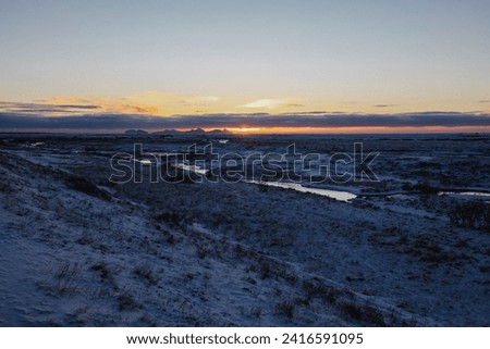 Winter Scene with snowy Mountains and Blue Sky in Iceland during sunset time