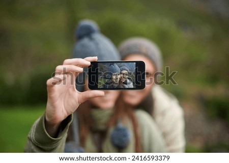 Couple, selfie and photo while hiking in nature, smartphone and capture moment in outdoors. People, happy and picture for memory and exploring wilderness, trekking and photograph for social media