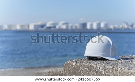 The sea and hard hats.Industrial area of the sea.