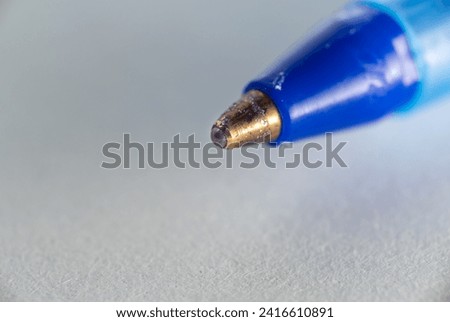 Detailed Macro Close-Up of a Well-Used Blue Ballpoint Pen Tip, Essential Writing Instrument for Office, Education, and Everyday Communication Royalty-Free Stock Photo #2416610891