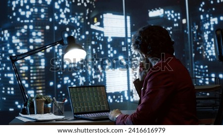 Skilled trader researching global economic conditions for the purpose of trading investments in finance, boost multinational legal earnings. Analyst working at nighttime to provide required capital. Royalty-Free Stock Photo #2416616979