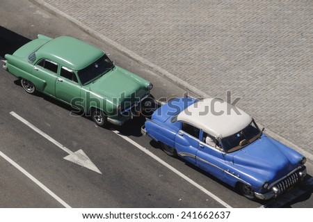 Old American cars on the road in Cuba.
