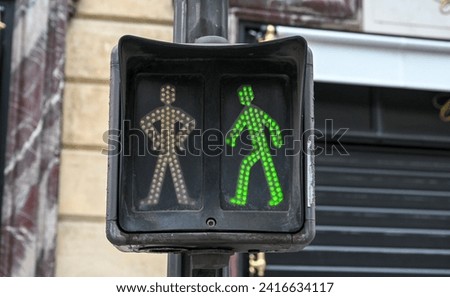 Green light on traffic lights for pedestrians. Traffic light on the street in Paris, France. Traffic signal.