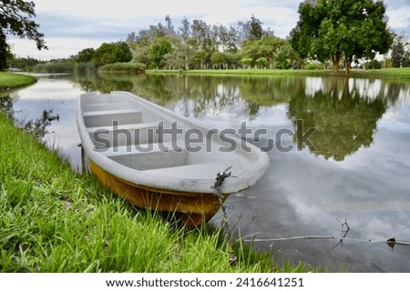 Boat parked at the lake, and the green nature makes the picture more beautiful. Best background picture with nature. 