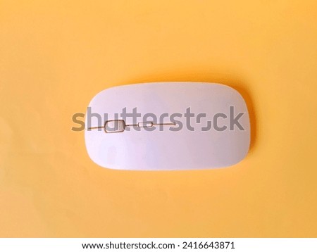 White wireless mouse on yellow background