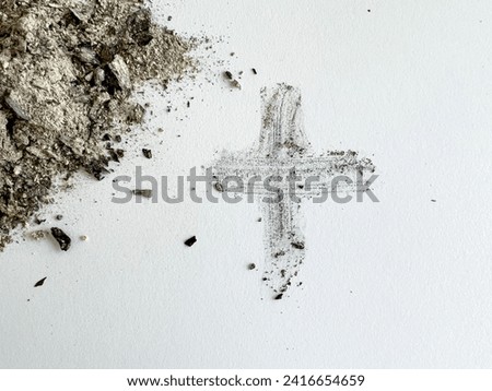 Ash Wednesday flat lay of ashes next to the ash cross. Ash Wednesday is the Christian symbol during the holy day of prayer and fasting preceded by Shrove Tuesday marking the first day of Lent. Royalty-Free Stock Photo #2416654659