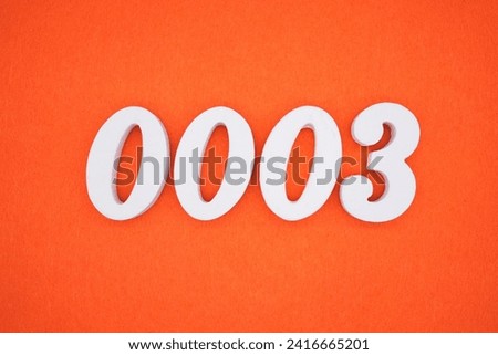 Orange felt is the background. The numbers 0003 are made from white painted wood.