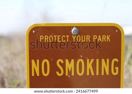 Outdoors informative park sign for no smoking