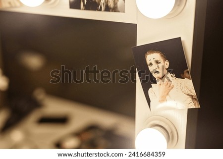 Close up of artists photo on vanity table with mirror backstage in circus or theater, copy space