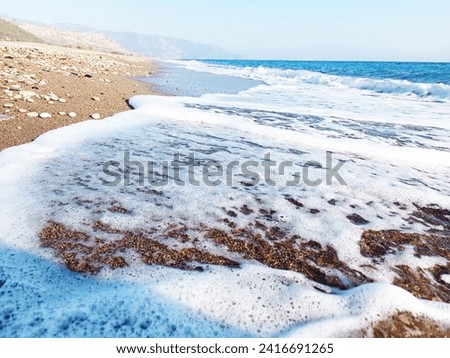 are you ready for summer? summer? clear blue sea, Magnificent aerial top view background photo of ocean sea water white wave splashing in deep sea. Drone photo background of sea wave in bird's eye wav