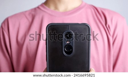 close-up of a man using a smartphone on a white background