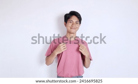 Handsome Asian man with a thin smile poses coolly on a white background Royalty-Free Stock Photo #2416695825