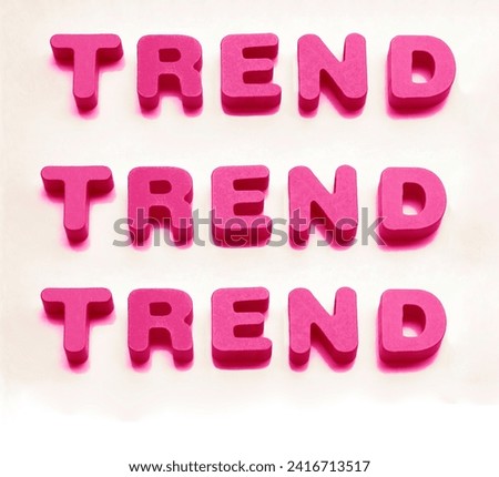 red Word made from colorful wooden letters  - TREND isolated on white background. Famous name, trendy goods, tendency concept. 