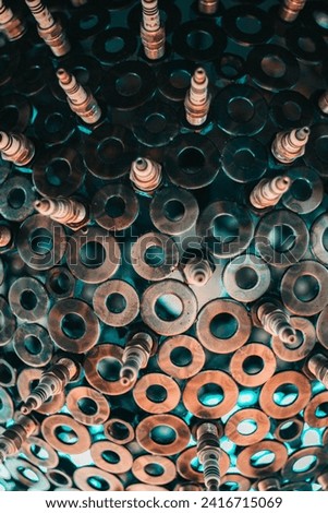 Industrial urban modern chic stylised pendant lighting made from washers and spark plugs. Royalty-Free Stock Photo #2416715069