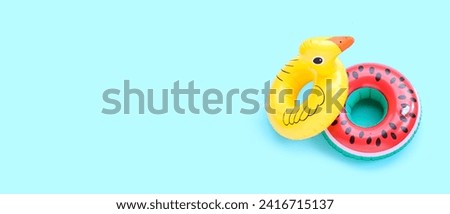 Inflatable rings on blue background. Royalty-Free Stock Photo #2416715137