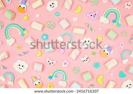 Trendy pastel pink kawaii background with cute air plasticine handmade cartoon animals, unicorns, stars, sweet marshmallows, rainbows pattern. Top view, flat lay. Candycore, fairycore. Royalty-Free Stock Photo #2416716107