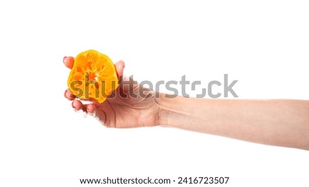 Tangerine in hand isolated on white background. High quality photo