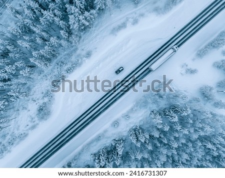 Aerial view of beautiful winter landscape and road in Lapland during sunset. Royalty-Free Stock Photo #2416731307