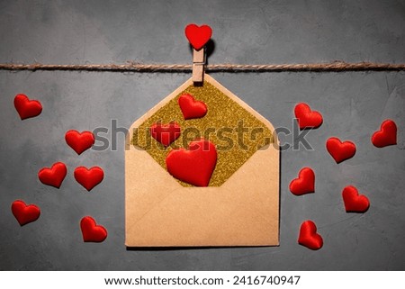 clothespin with red heart on a rope on a gray background. an envelope with a red heart inside. symbol of love, passion. flat lay, top view, Love, Valentine's Day February 14, Wedding Royalty-Free Stock Photo #2416740947