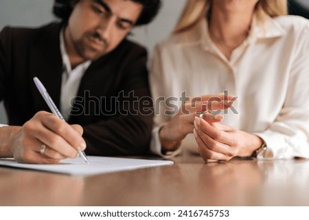 Cropped shot of sad spouses couple signing decree papers getting divorced in lawyers office at desk. Unhappy married man and woman filing divorce, shares or mortgage assets with attorney. Royalty-Free Stock Photo #2416745753