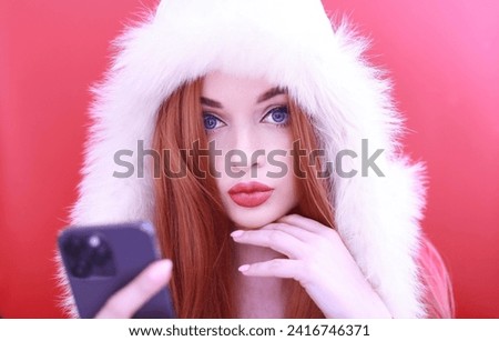 Portrait of a beautiful young woman in winter clothes talking on the phone