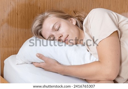 Feeling calmness. Sleepy female keeping eyes closed sleeping at hotel room.