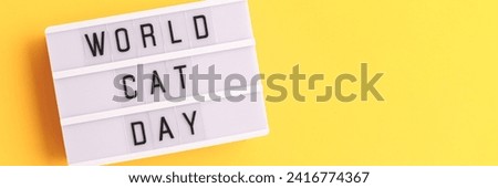 World cat day. Banner with white lightbox with letters on a yellow background. Place for text.