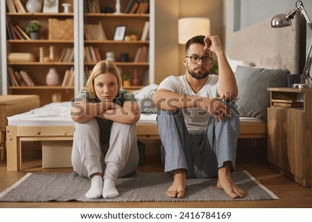 Upset couple ignoring each other after fight in bedroom Royalty-Free Stock Photo #2416784169