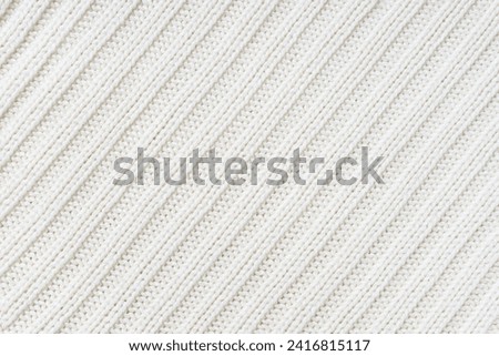 Jersey textile background , white diagonal striped knitted fabric. Woolen knitwear, sweater, pullover surface texture, textile structure, cloth surface, weaving of knitwear material Royalty-Free Stock Photo #2416815117