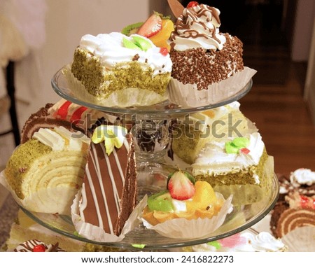 The image shows a tray of cupcakes, featuring various flavors and icing styles.
