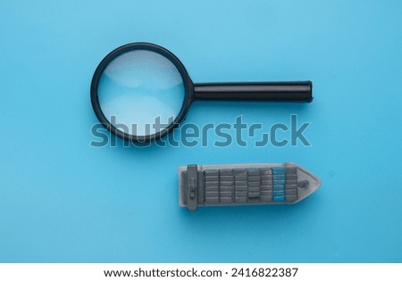 A picture of vessel miniature and magnifying glass. Search booking shipment