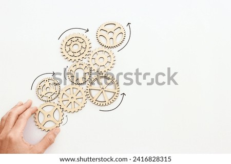 Hand spinning gears on a white background