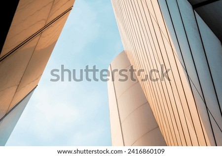 wall of a modern building on a background of blue sky abstract architectural background Royalty-Free Stock Photo #2416860109