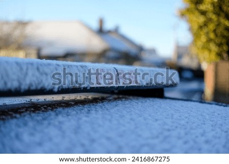 Snow settling on Fire car during winter cold snap  Royalty-Free Stock Photo #2416867275