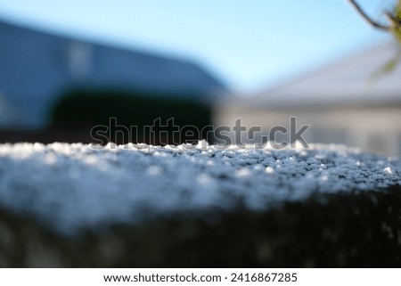 Snow settling on a shed roof during winter cold snap  Royalty-Free Stock Photo #2416867285